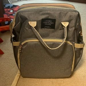Gray diaper bag with gold details. Like new.